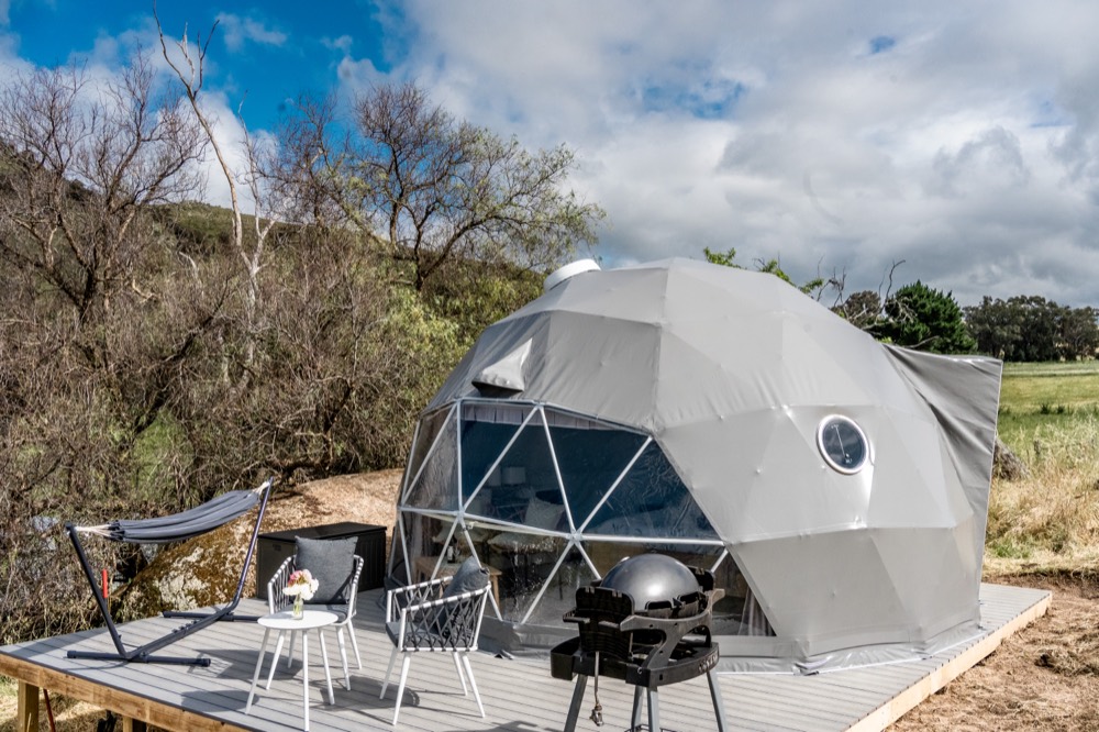 The Peppertree Dome at La Paloma Farm, a geodesic glamping dome on a deck with hammock and BBQ overlooking farm paddocks near Cowra in the NSW Central West