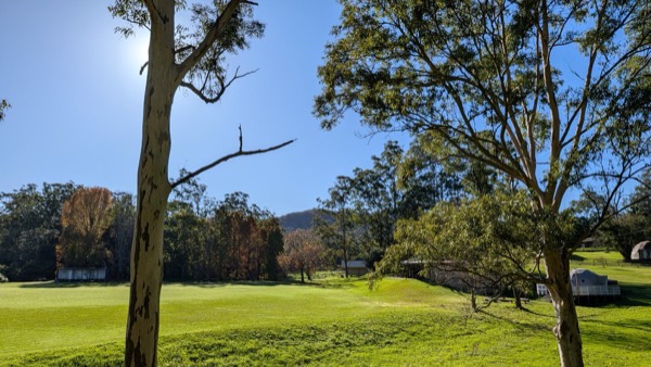 Wide view across the Unwind Escapes property in Dooralong Valley, Central Coast NSW