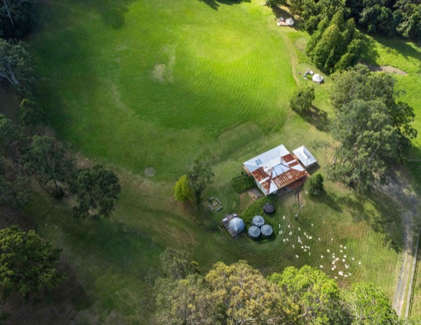 Aerial view of the solar-powered Unwind Escapes glamping property among the trees in Dooralong Valley, NSW