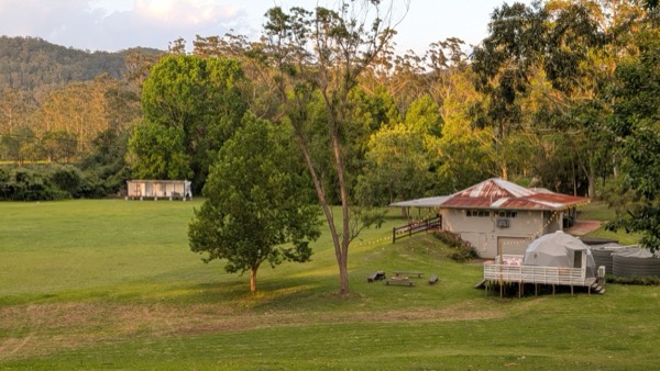 Aerial view over the Unwind Escapes glamping property and the surrounding Dooralong Valley, Central Coast NSW