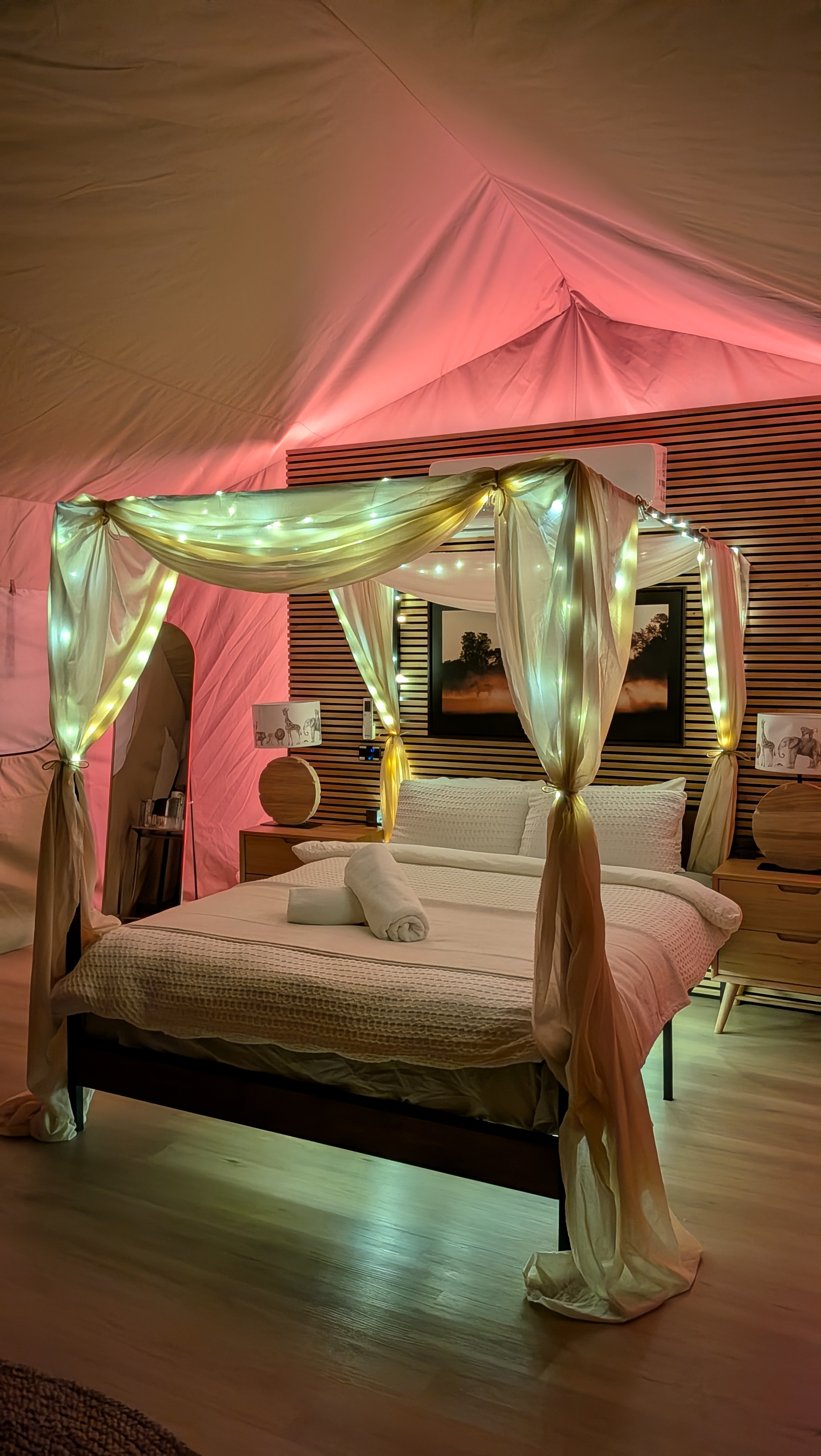 4-poster queen bed with warm ambient lighting at dusk
