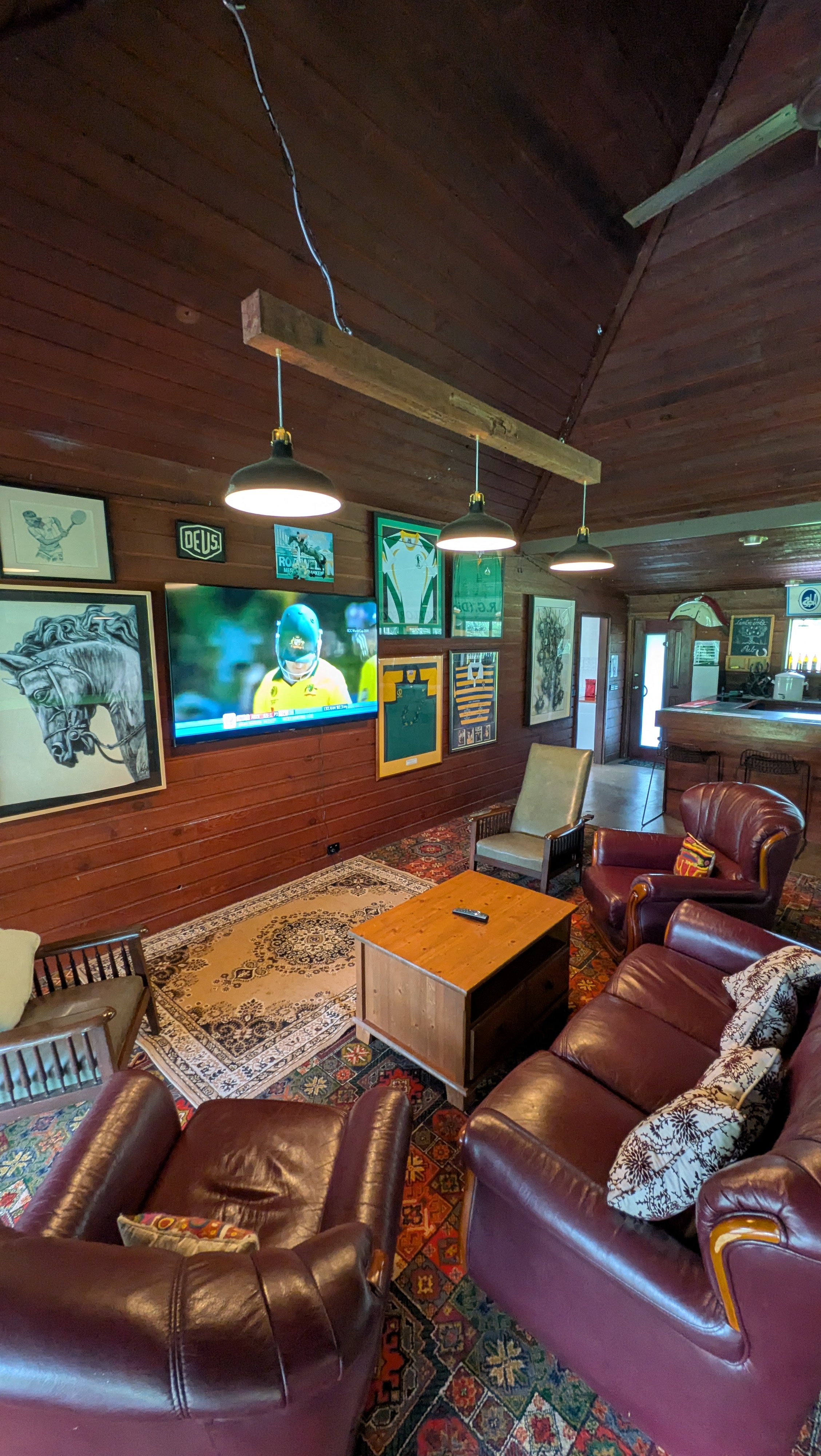 Shared clubhouse lounge with comfortable seating and memorabilia