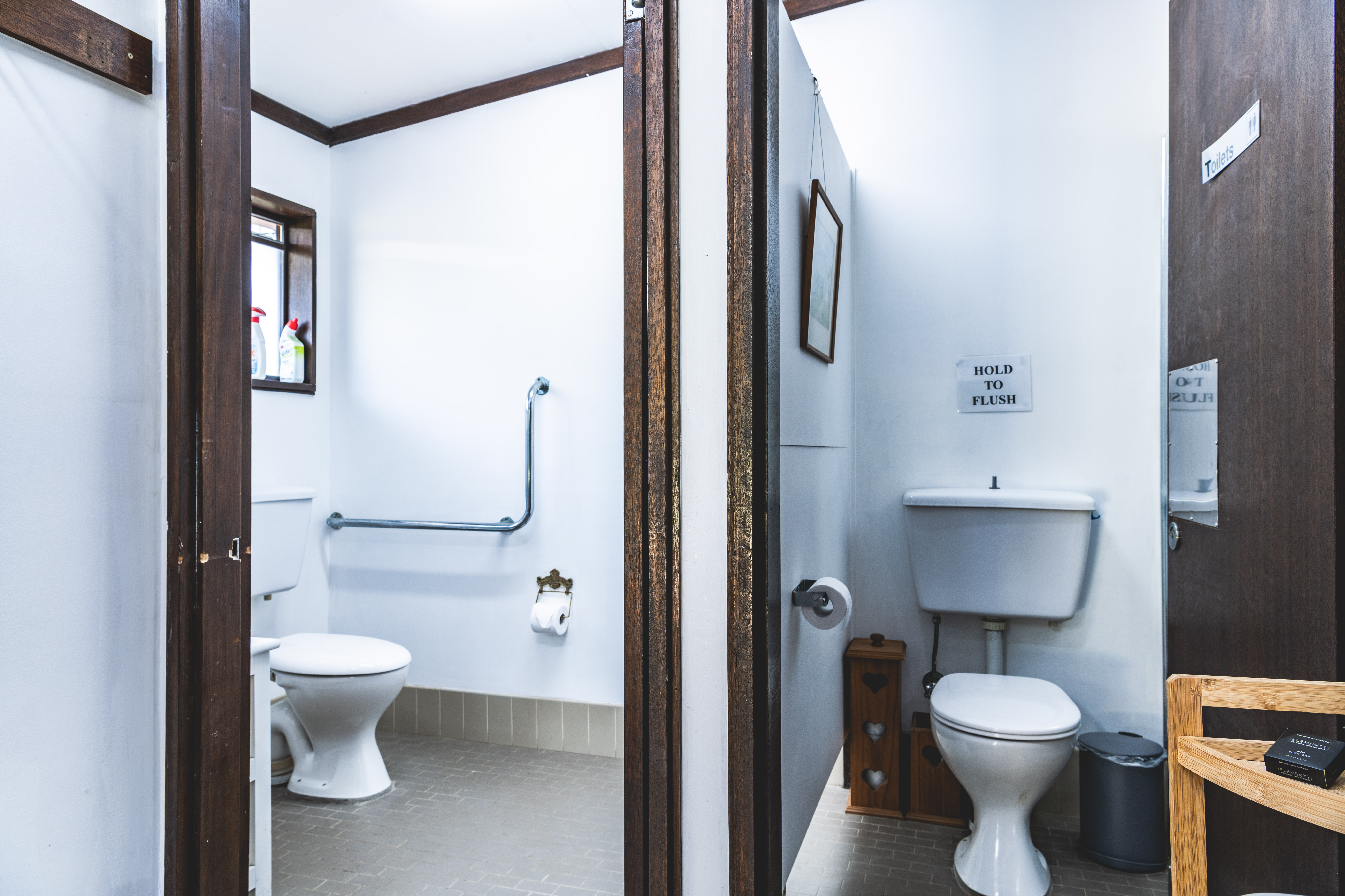 Shared bathroom — double basin, 2 toilet cubicles (one accessible)