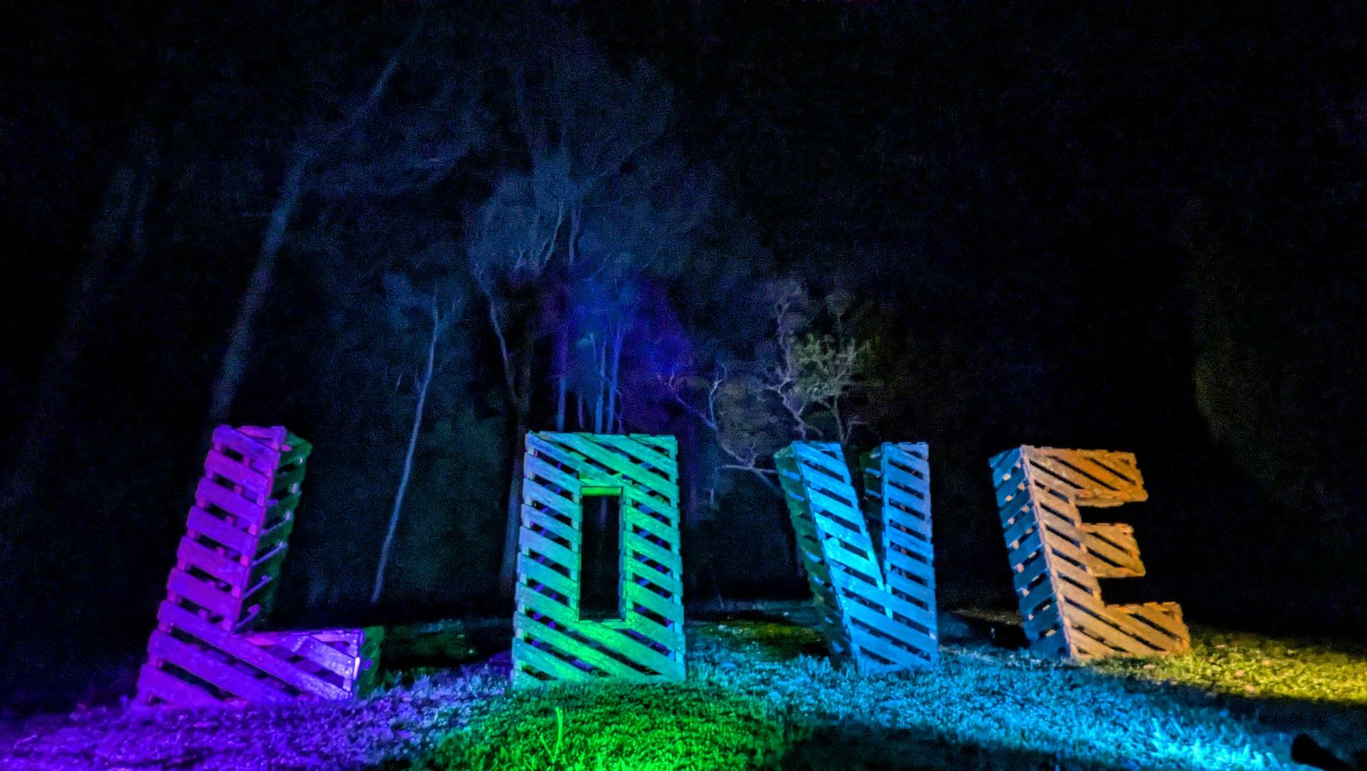 Illuminated LOVE sign on the property at night