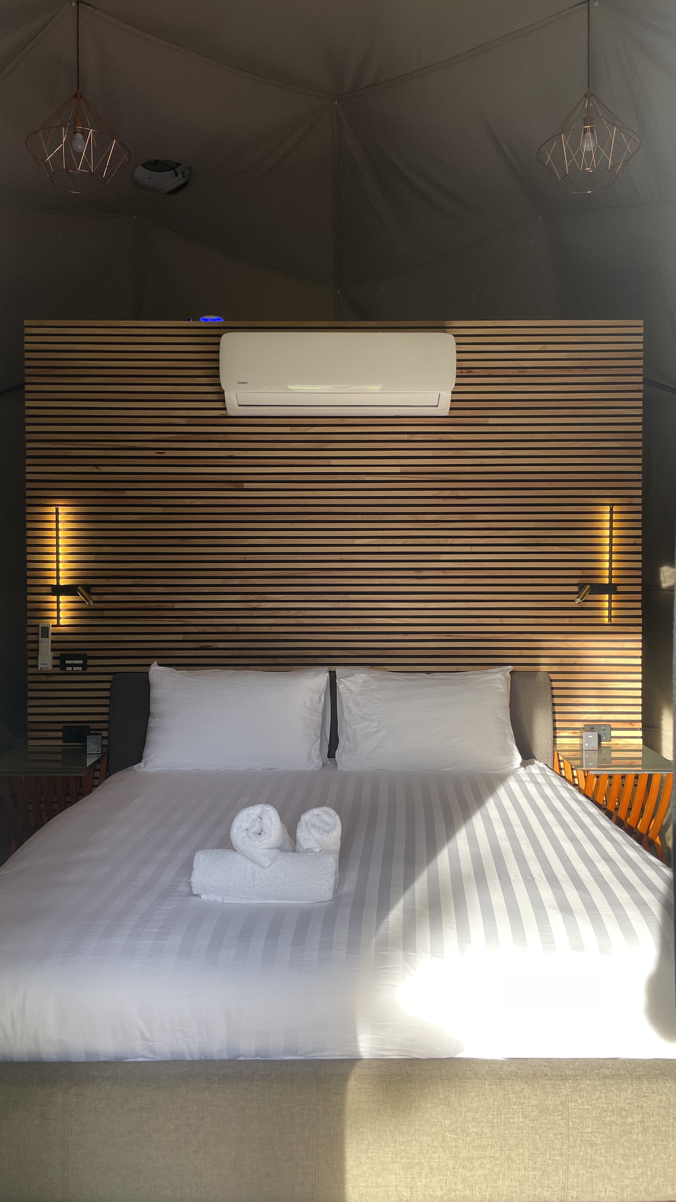 The Nest Glamping Dome king bed and timber feature wall