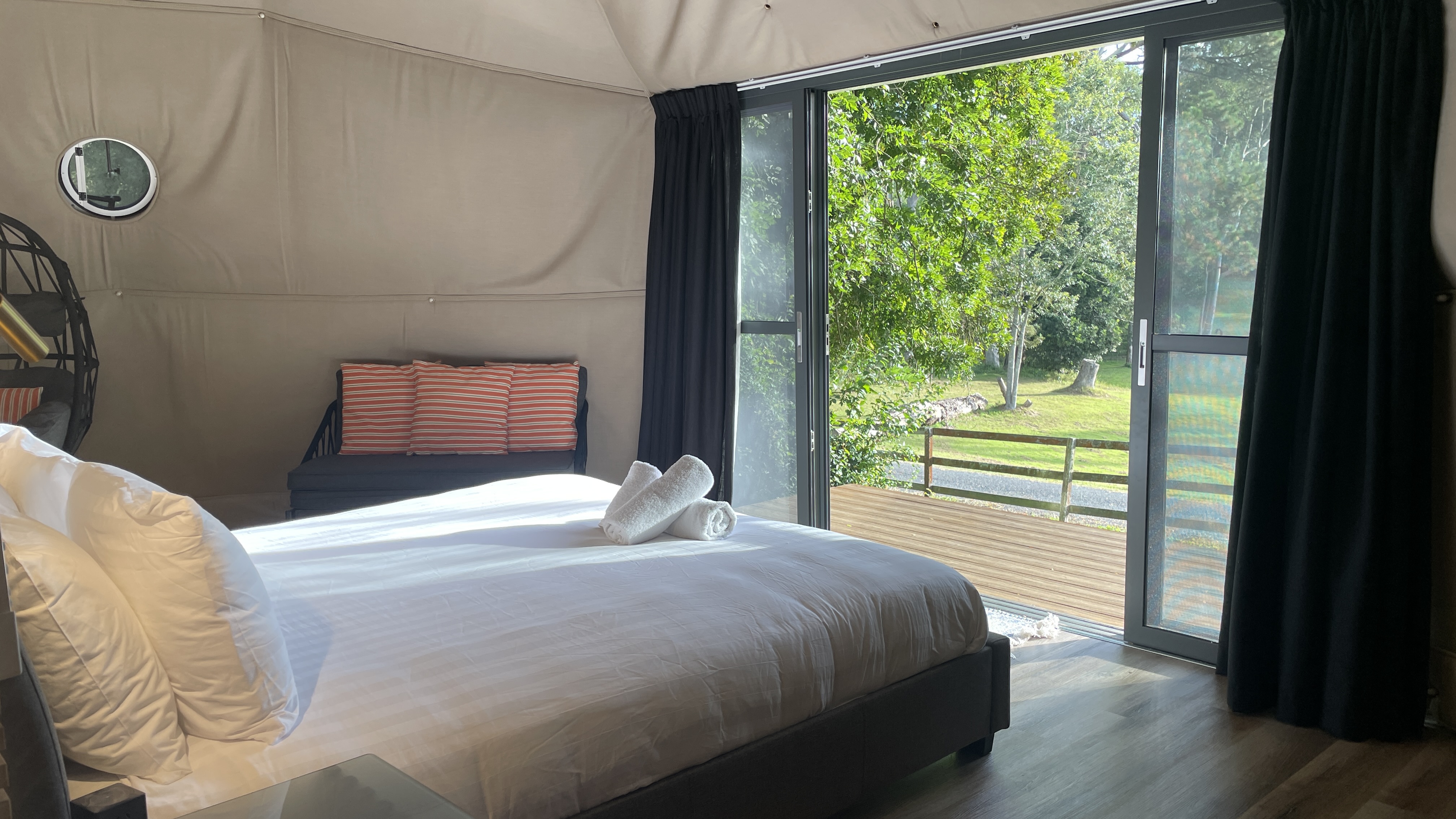 The Nest Glamping Dome modular couch with view through glass doors