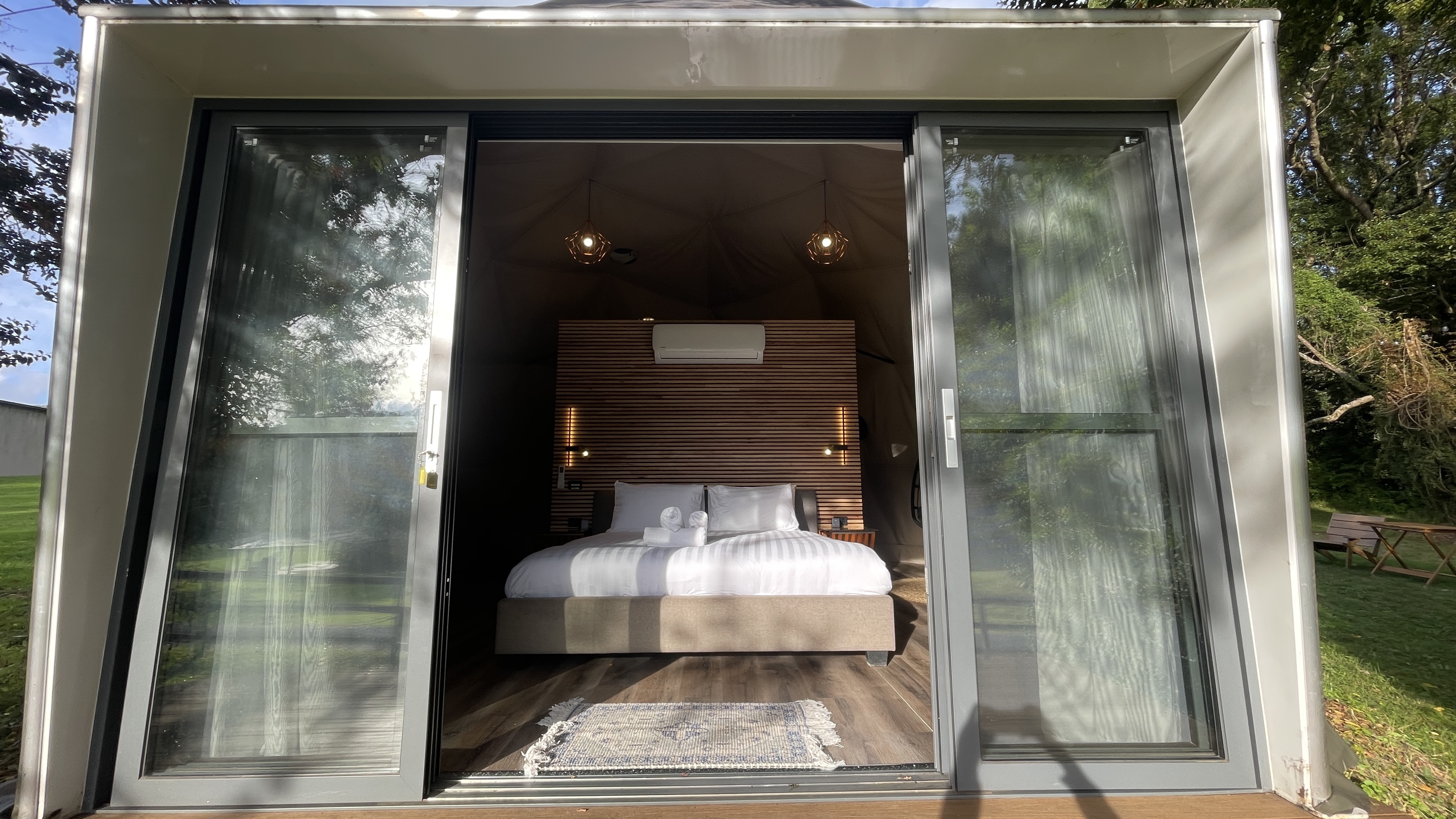 View through the entrance doors towards the king bed