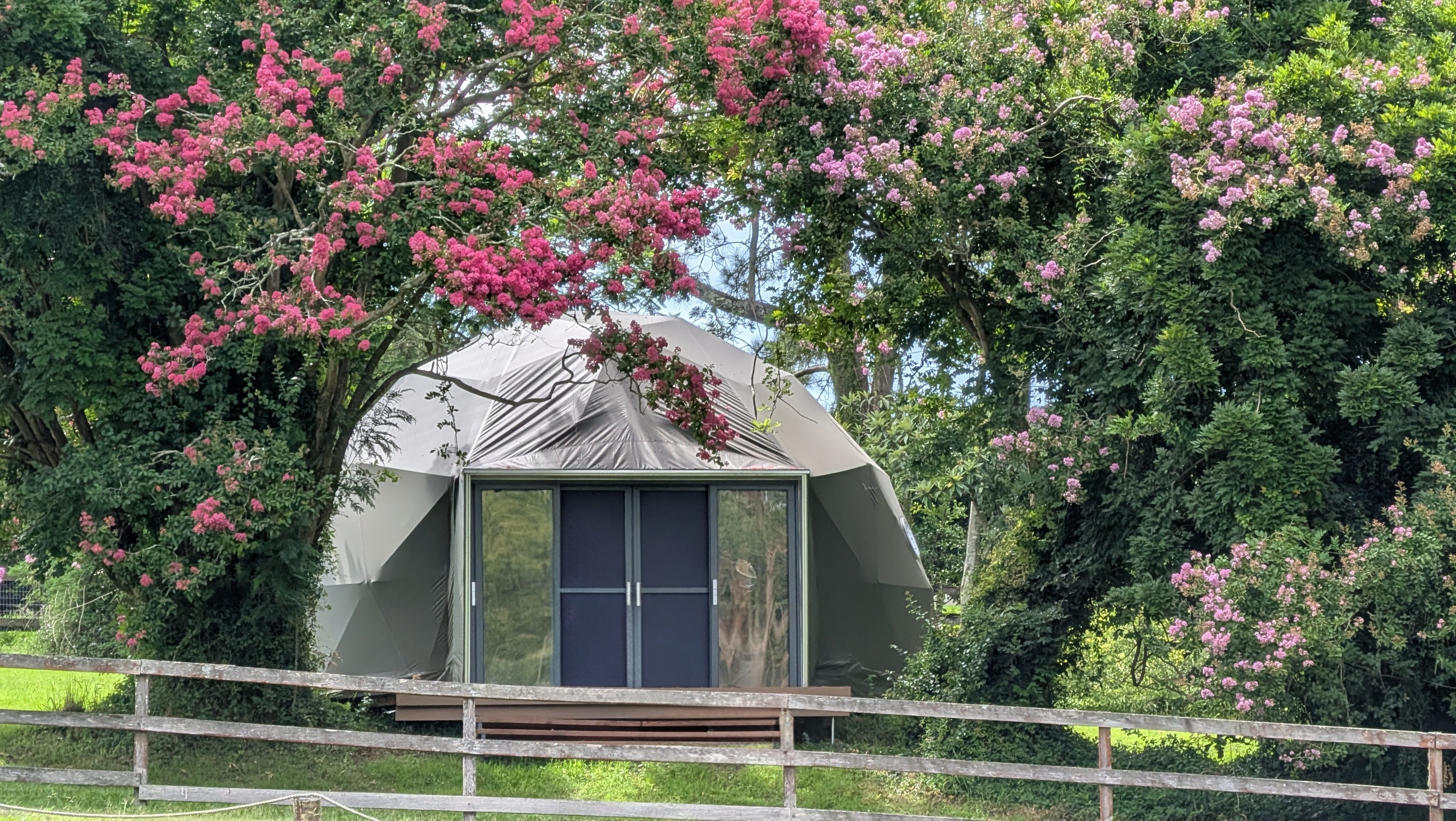 The Nest dome with floral archway and garden setting