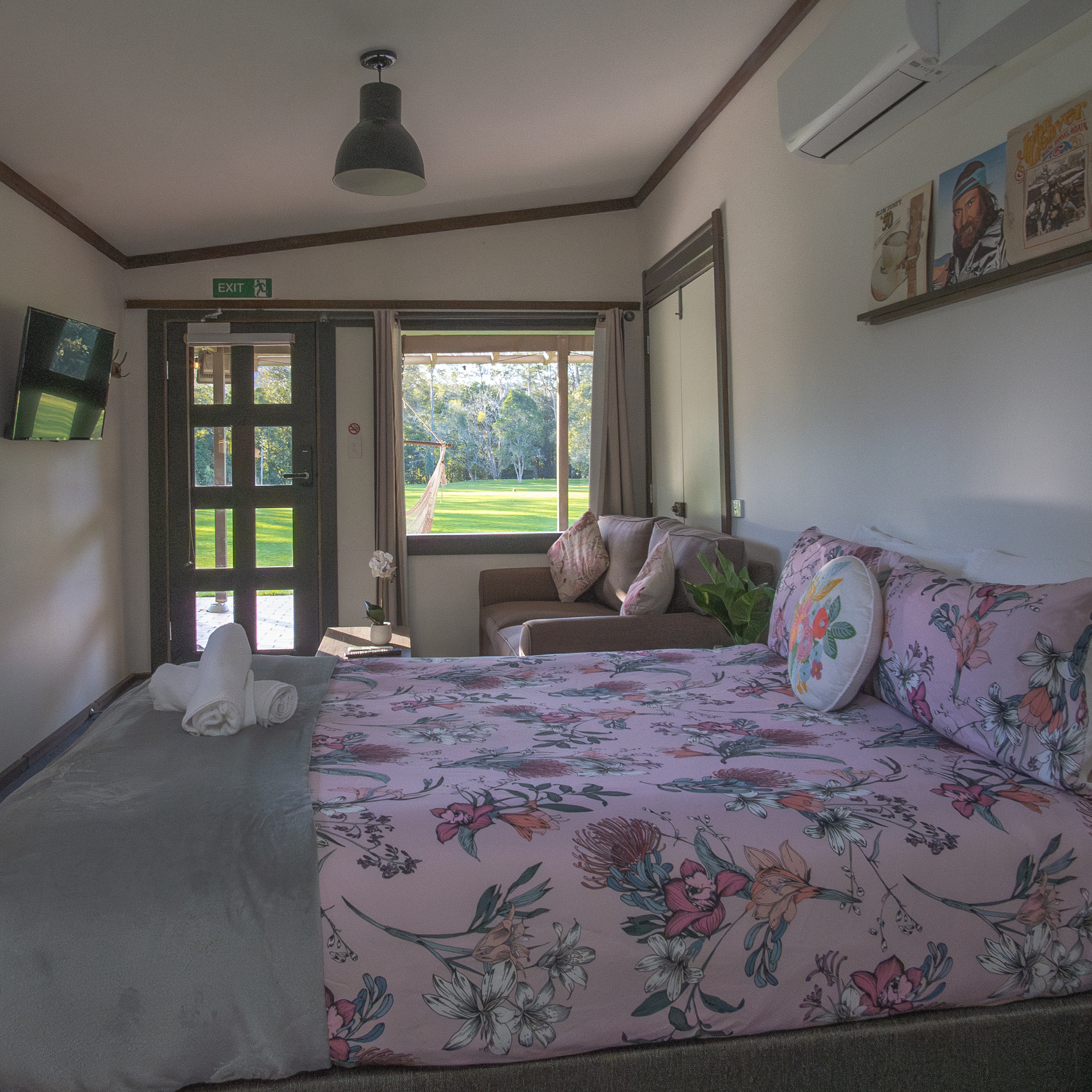 View from the queen bed with natural light and bushland outlook