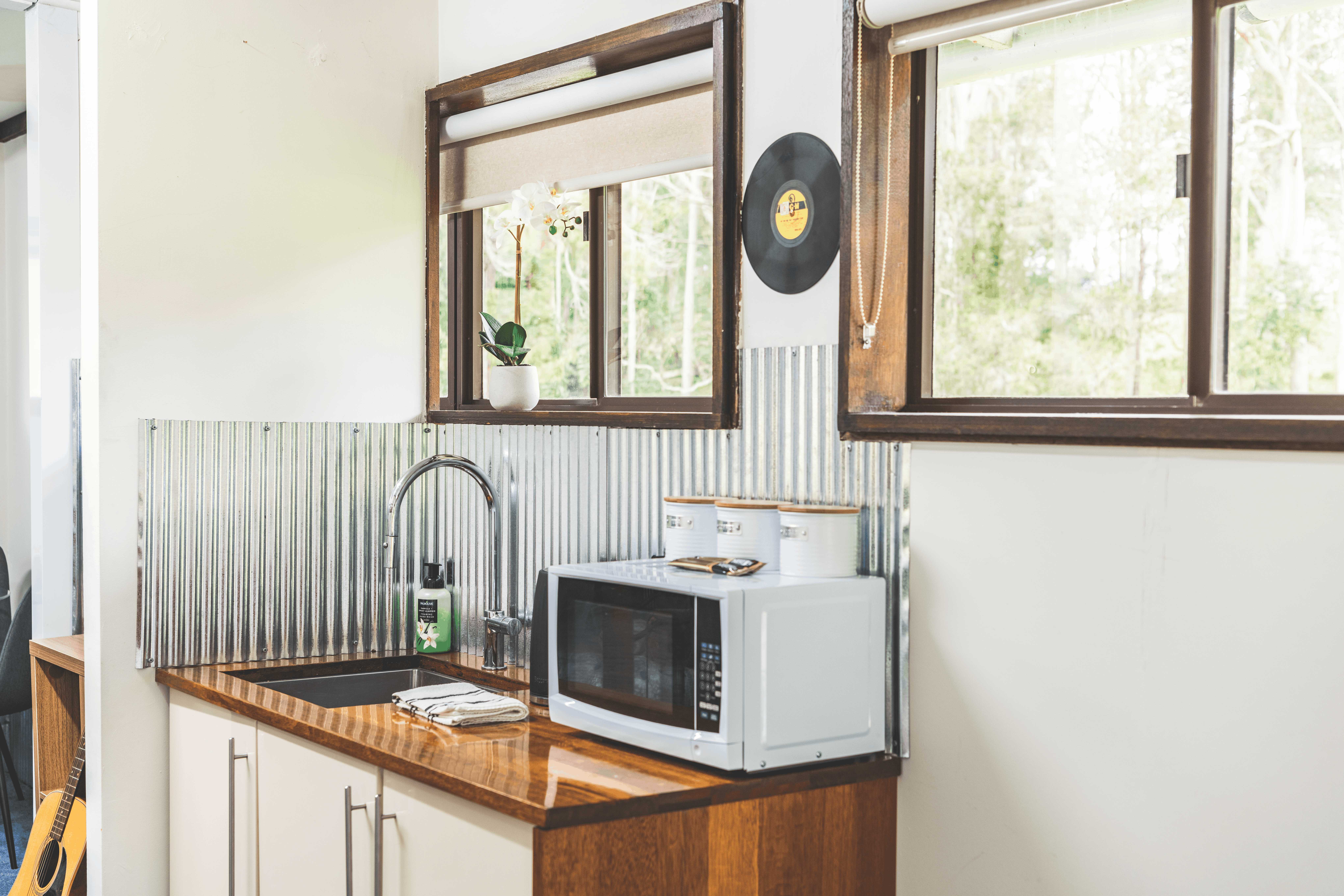 In-room kitchenette with mini fridge, kettle, and tea and coffee station