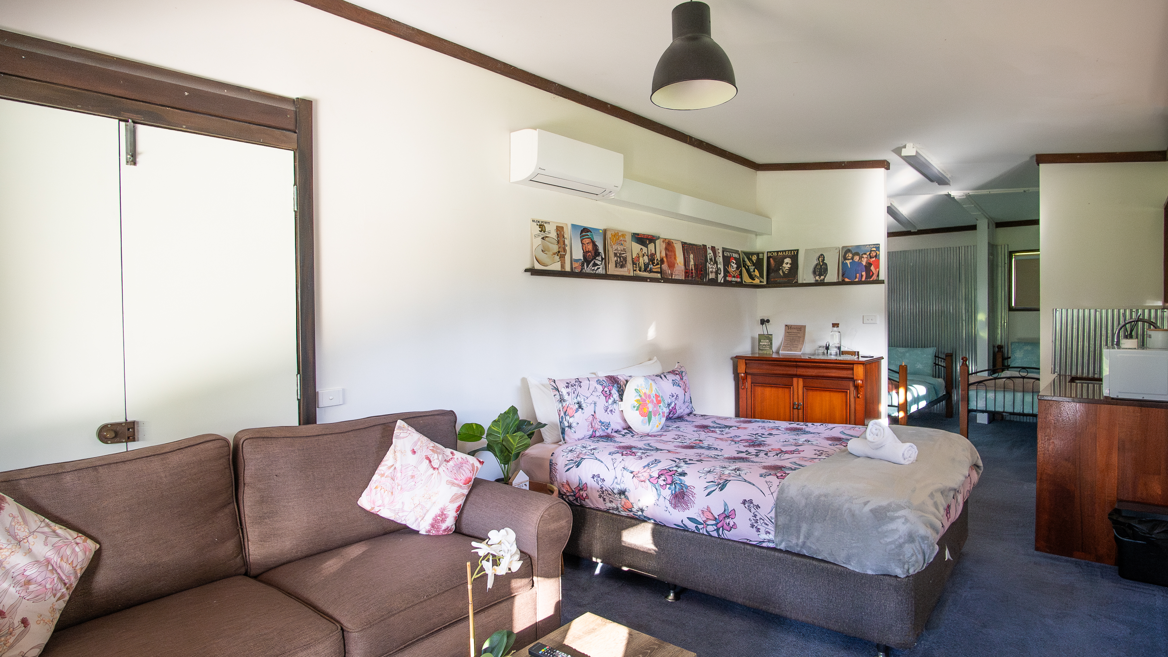 Queen bed with quality linen, Smart TV, air conditioning, and couch